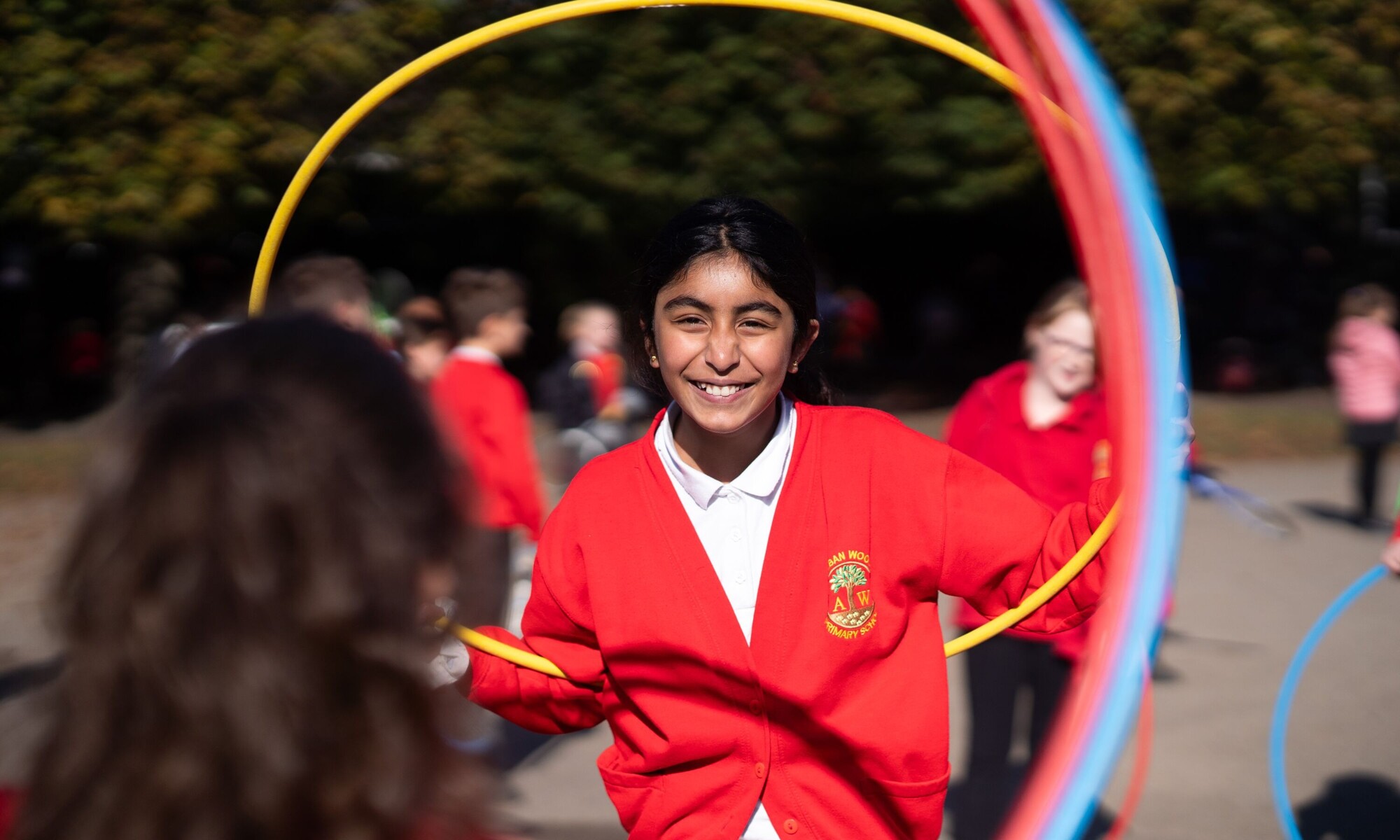 Alban Wood Infant pupils playing outside with hula hoops