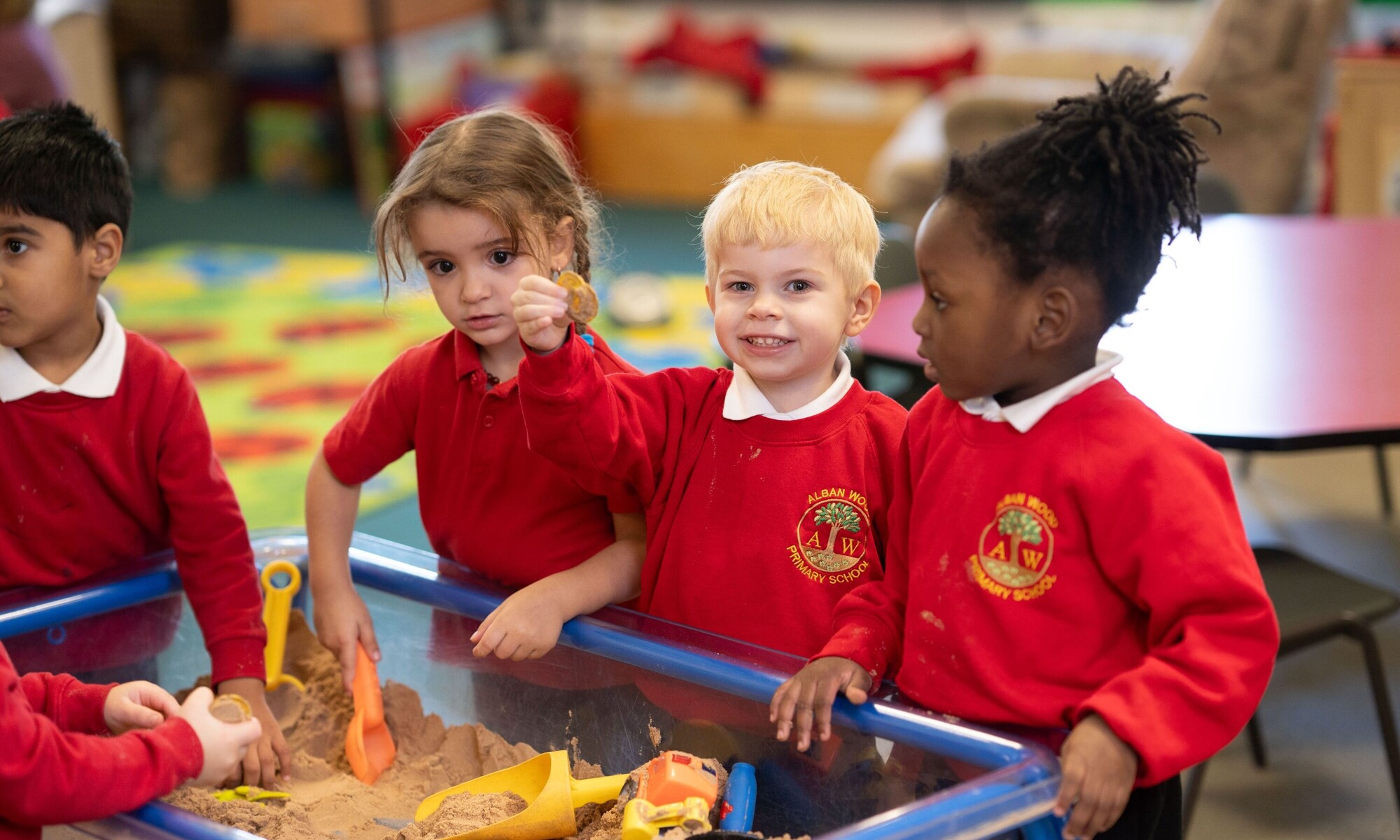 Alban Wood Infant pupils playing together in a sandpit
