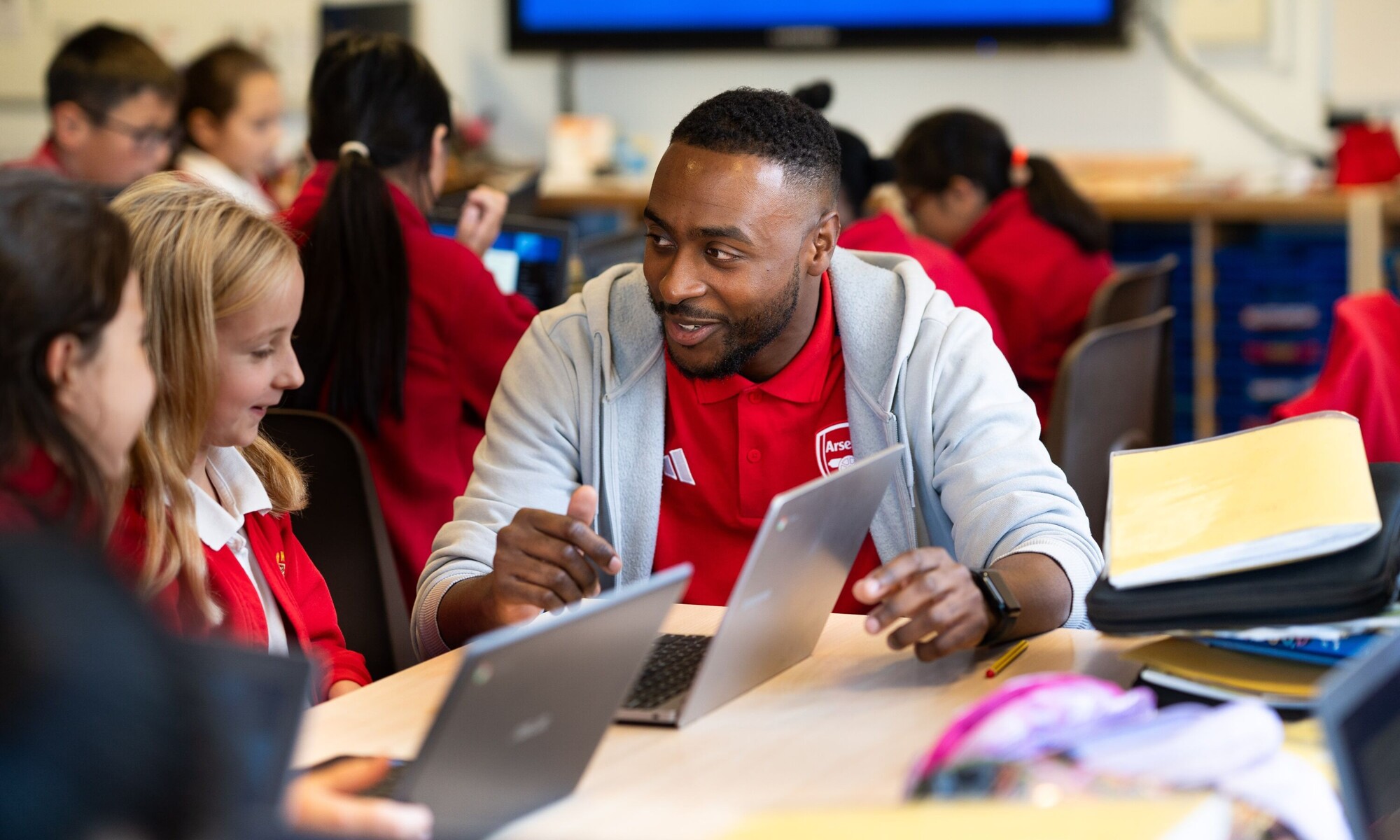 Alban Wood Infant pupils with teacher helping to study