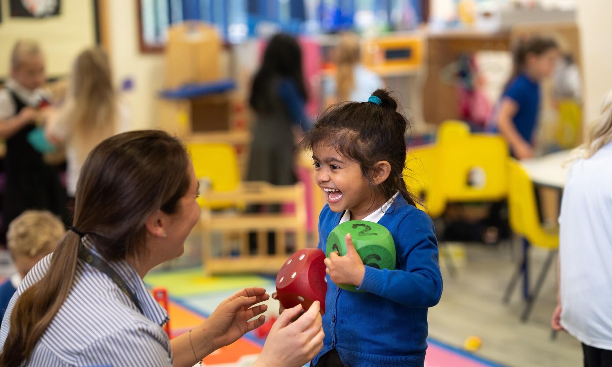 Warren Dell Primary School teacher helping a pupil in a maths lesson