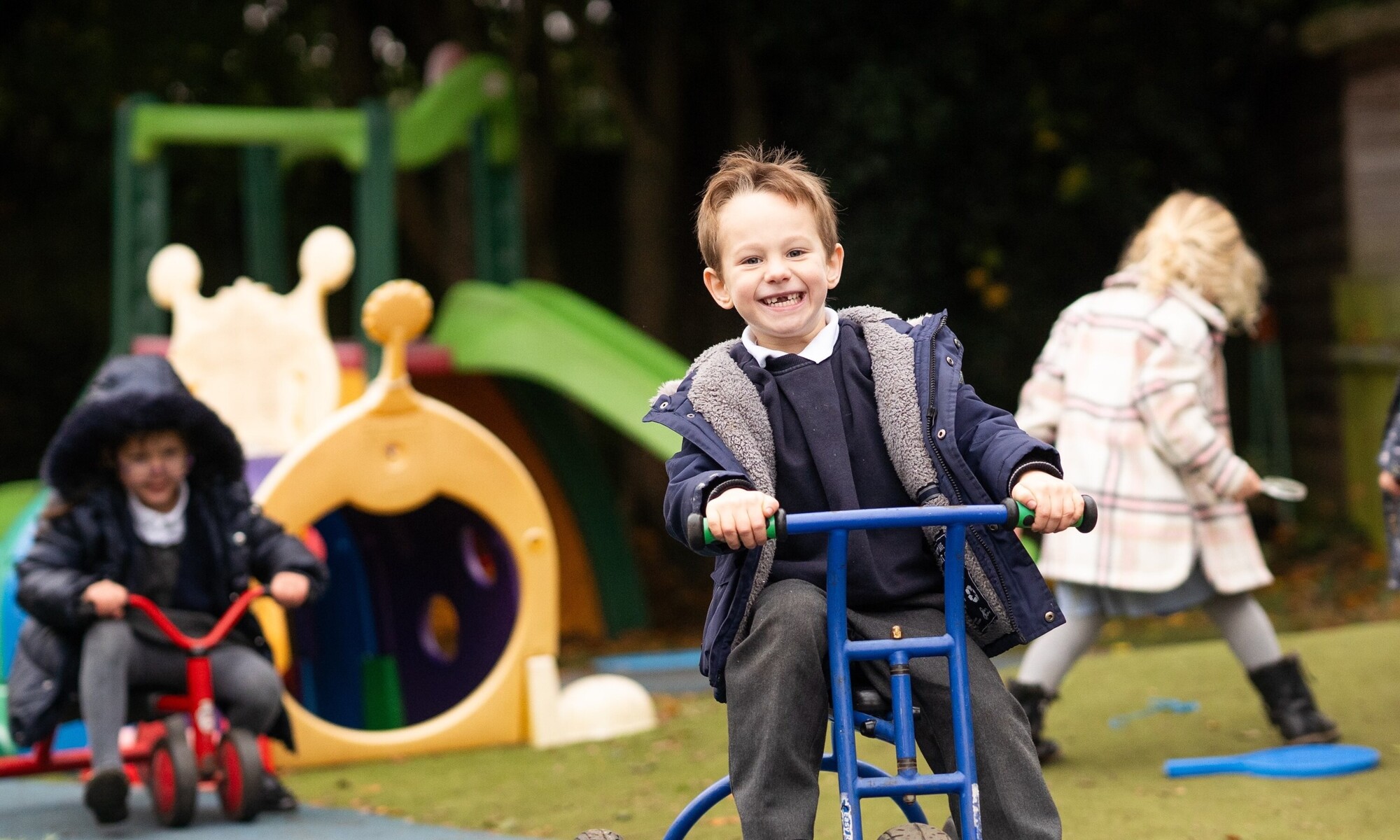 Student having fun playing with the tricycle
