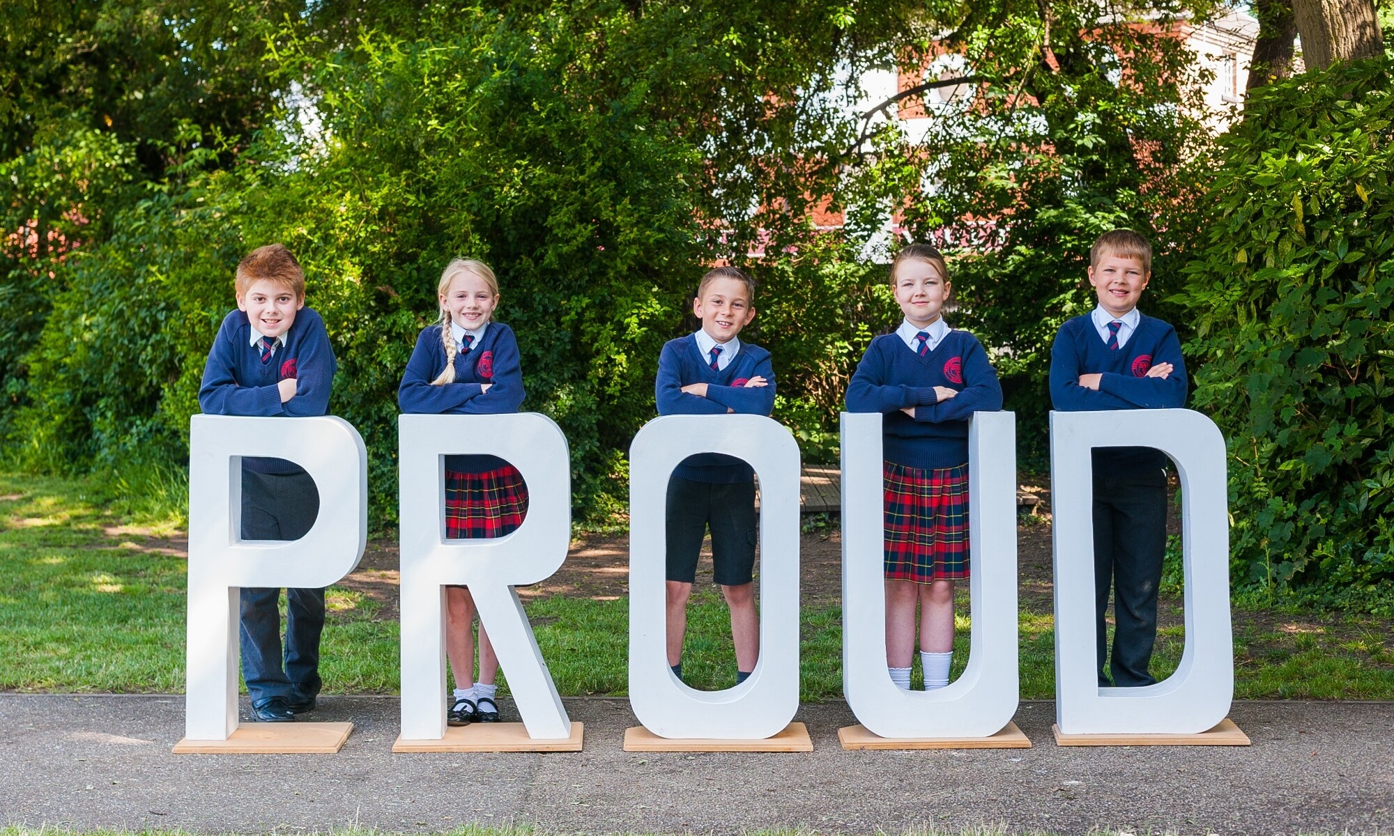 Brooke Weston Trust pupils behind a sign