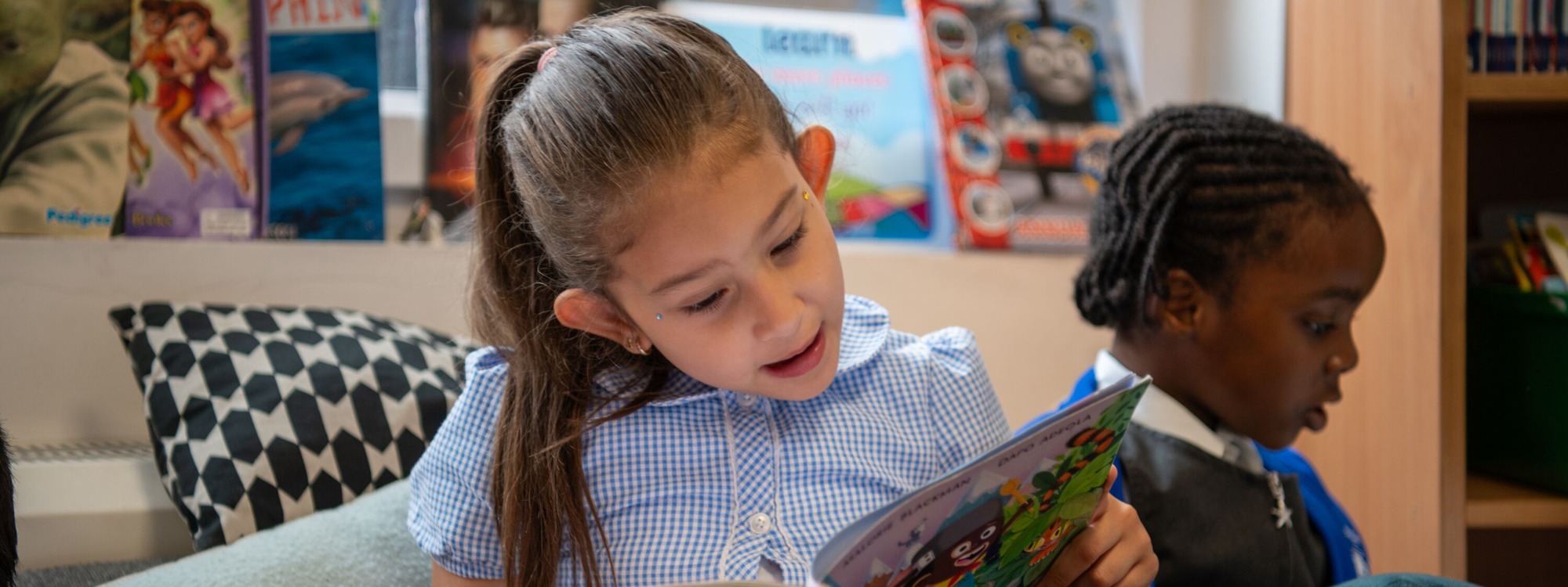 Childeric Primary School Student Reading in Library