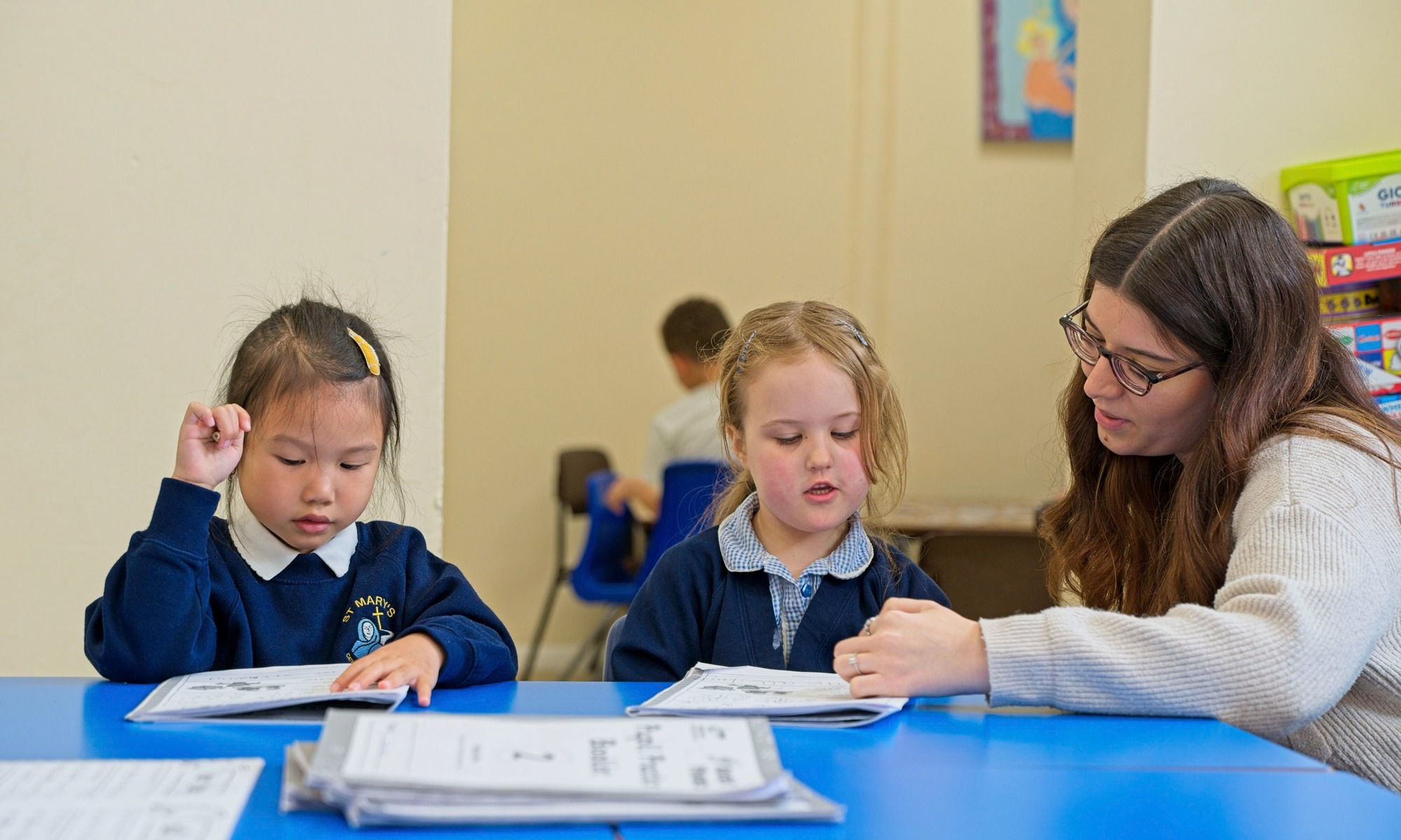 St Mary's Catholic Primary teacher helping pupils with their work