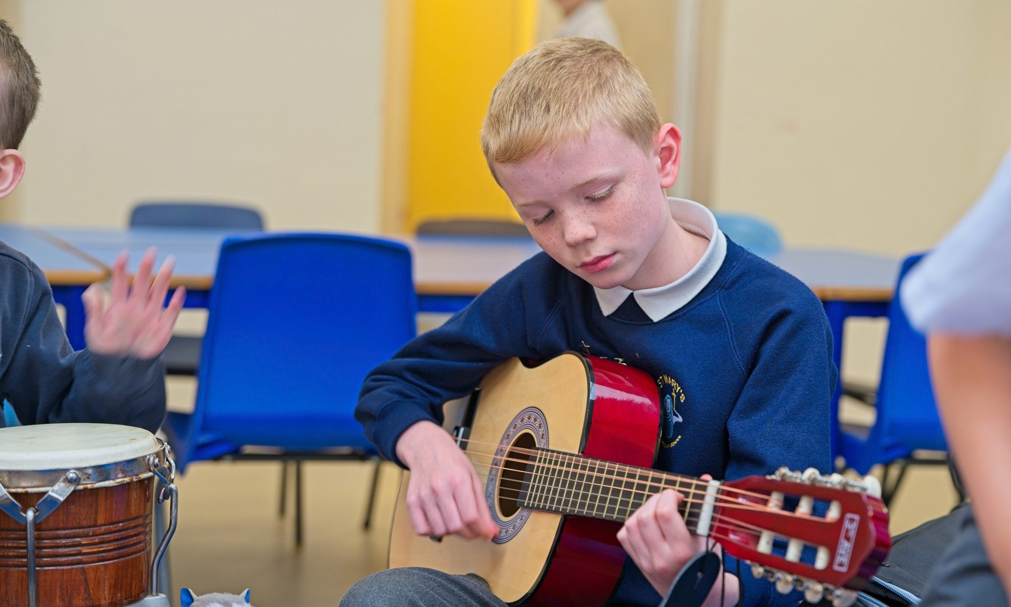 St Mary's Catholic Primary pupil playing the guitar