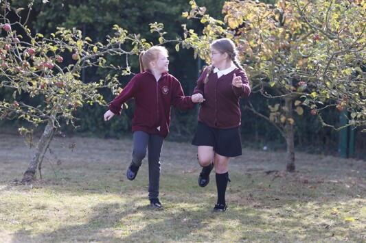 Alton Park Pupils skipping outside in orchard