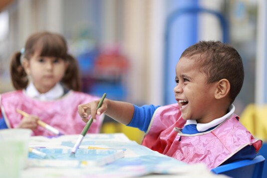 Monkwick Infant and Nursery School - Two Pupils in Art Class with Pink Aprons